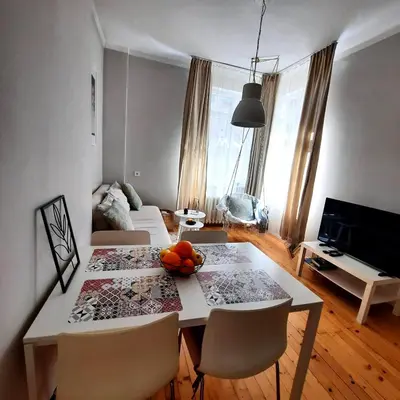 a living room with a table with a bowl of fruit on it at Cozy & Stylish apartment in the heart of Sofia in Sofia