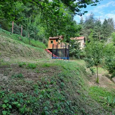 a house on top of a hill with a playground at 
