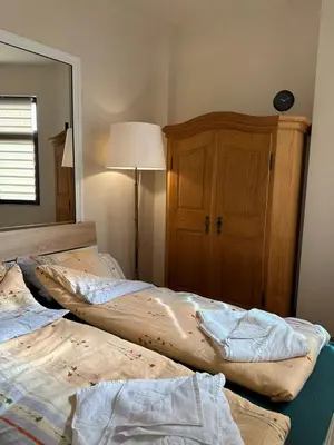 two beds in a bedroom with a lamp and a mirror at Ози 1 Допълнителна къща за гости in Ovchartsi
