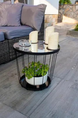 a table with candles and plants on a patio at Допълнителна къща за гости Ози 2 in Ovchartsi