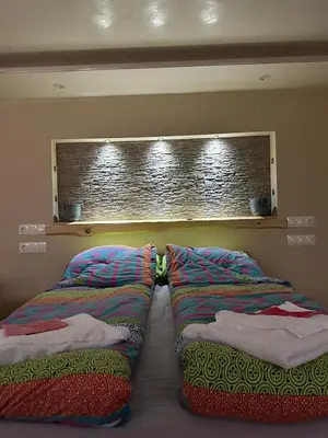 two pillows sitting next to each other on a bed at Допълнителна къща за гости Ози 2 in Ovchartsi