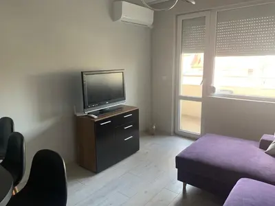 a living room with a tv and a couch at Pazardzhik suite home in Pazardzhik