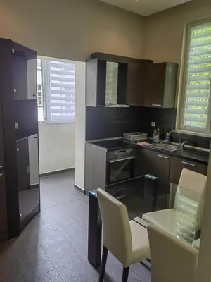 a kitchen with a table and chairs and a counter top at Vitosha 67 in Sofia