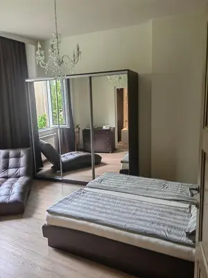 a bedroom with a bed and a large mirror at Vitosha 67 in Sofia