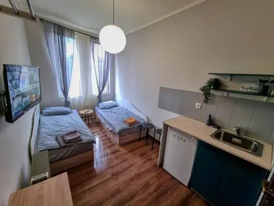 a small room with a bed and a kitchen at Charming Studio in Sofia Center in Sofia
