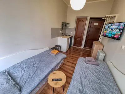 a small room with two beds and a table at Charming Studio in Sofia Center in Sofia