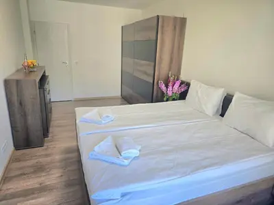 a bedroom with a large white bed with towels on it at Hotel Adria in Sofia