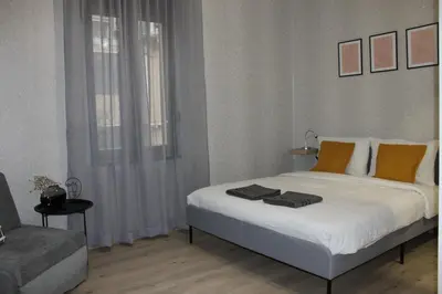 a bedroom with a large bed and a couch at Orange House in the Old Town Plovdiv- free parking in Plovdiv