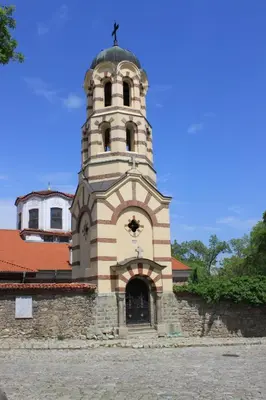 a building with a tower with a cross on it at Orange House in the Old Town Plovdiv- free parking in Plovdiv