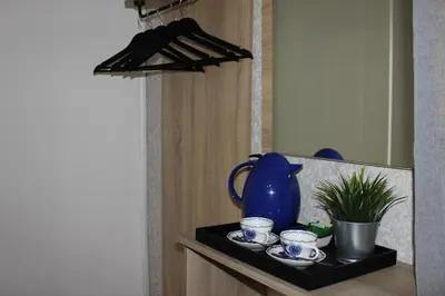 a black shelf with a blue pitcher and cups on it at Orange House in the Old Town Plovdiv- free parking in Plovdiv