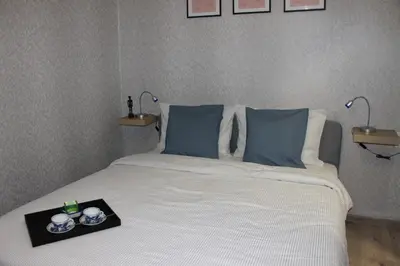 a bed with blue pillows and a tray on it at Orange House in the Old Town Plovdiv- free parking in Plovdiv