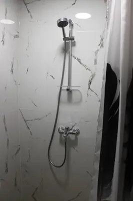 a bathroom with a shower with a hose at Orange House in the Old Town Plovdiv- free parking in Plovdiv