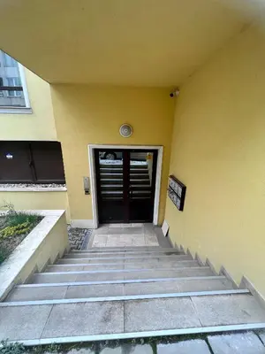 a door to a building with stairs leading to it at Vitosha Terrace 1BR Apartment with Parking in Sofia