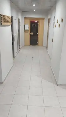 a hallway of an office building with white tile floors at Belvedere Holidey Clab apartament L403 in Bansko