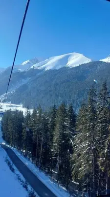 a gondola ride over a snow covered mountain at Belvedere Holidey Clab apartament L403 in Bansko
