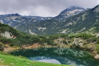 a mountain lake in the middle of a valley at Belvedere Holidey Clab apartament L403 in Bansko