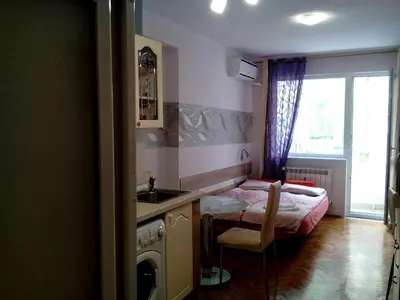a kitchen with a sink and a bed in a room at Studio Rositza in Sofia