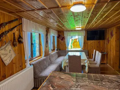 a room with a table and chairs in a train car at Златкова къща in Koprivshtitsa