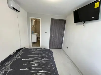 a bedroom with a bed and a flat screen tv at Еделвайс Edelvais in Kostenets Village