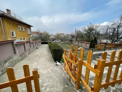 a wooden fence in front of a house at Еделвайс Edelvais in Kostenets Village