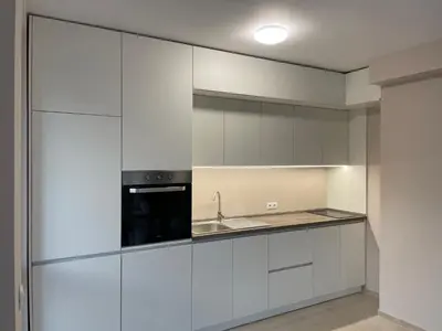 a kitchen with white cabinets and a sink at Apartment Mladost 2 - Free Parking in Sofia