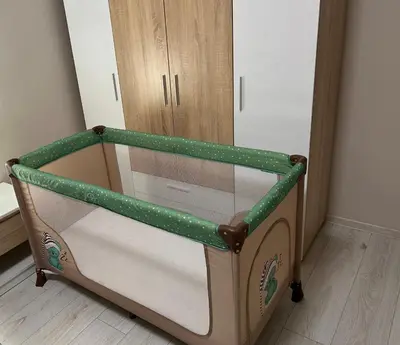 a doll crib with a green and white frame at Apartment Mladost 2 - Free Parking in Sofia