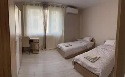 a small room with two beds and a window at Apartment Mladost 2 - Free Parking in Sofia