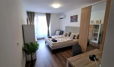 a living room with a couch and a table at Luxury Quiet Apartment in the City Center in Plovdiv