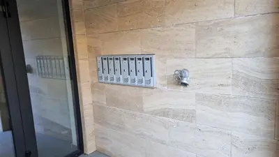 a shower in a bathroom with a stone wall at Luxury Quiet Apartment in the City Center in Plovdiv