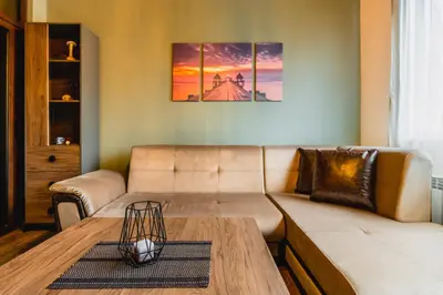 a living room with a couch and a table at Eagles' Bridge - 1BD Flat with Desk by Flat Mаnager in Sofia