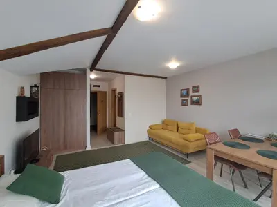 a bedroom with a bed and a living room at Large studio with view in Borovets Gardens in Borovets
