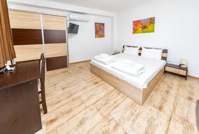 a bedroom with a bed and a wooden floor at Къща за приятели Недкови in Vasil Levski