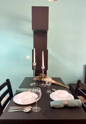 a black table with plates and wine glasses on it at Flower house 8 in Sofia