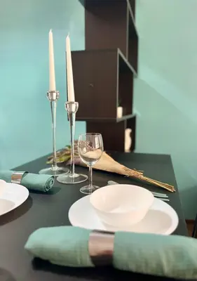 a black table with plates and wine glasses and candles at Flower house 8 in Sofia