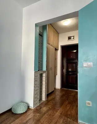 a hallway with a door and a room with wooden floors at Flower house 8 in Sofia