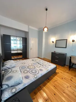 a bedroom with a large bed and a flat screen tv at CityPulse Apt in Ideal Center w Working Space in Sofia