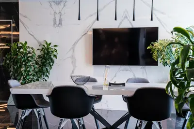 an office with a desk with chairs and a tv at Sofia Paradise View Apartment in Sofia