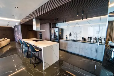 a kitchen with a counter and some chairs in it at Sofia Paradise View Apartment in Sofia