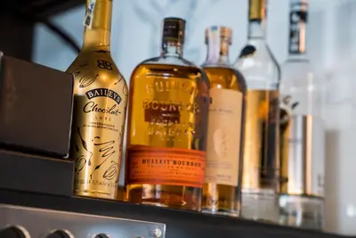 a row of bottles of alcohol on a shelf at Sofia Paradise View Apartment in Sofia
