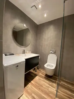 a bathroom with a toilet and a sink and a mirror at Sofia Paradise Lux Apartment in Sofia