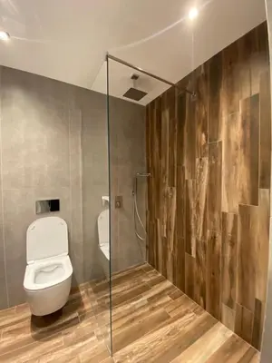 a bathroom with a toilet and a glass shower stall at Sofia Paradise Lux Apartment in Sofia