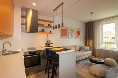 a kitchen and living room with a sink and a counter at Heart of Sofia Studio in Sofia