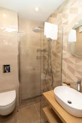 a bathroom with a shower and a toilet and a sink at Heart of Sofia Studio in Sofia