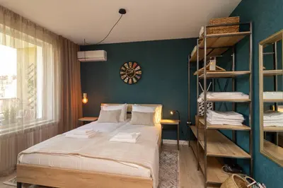 a bedroom with a bed and a green wall at Heart of Sofia Studio in Sofia