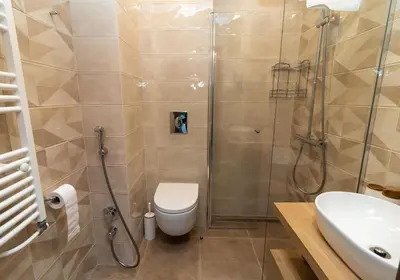 a bathroom with a shower and a toilet and a sink at Heart of Sofia Studio in Sofia
