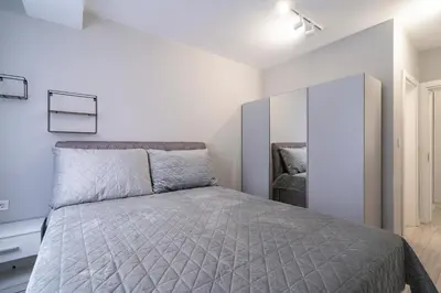 a bedroom with a large bed and a mirror at COOP Apartments, Sofia - Free Parking in Sofia