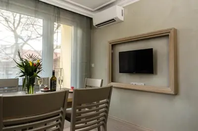 a dining room with a television and a table with chairs at COOP Apartments, Sofia - Free Parking in Sofia