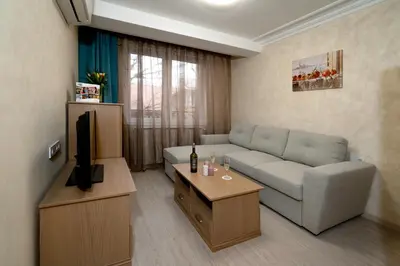 a living room with a couch and a television at COOP Apartments, Sofia - Free Parking in Sofia