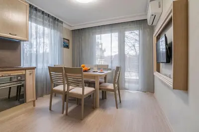 a kitchen and dining room with a table and chairs at COOP Apartments, Sofia - Free Parking in Sofia