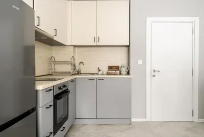 a white kitchen with white cabinets and a sink at COOP Apartments, Sofia - Free Parking in Sofia